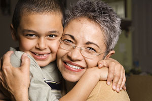 grandma hugging boy at magic show for kids birthday party